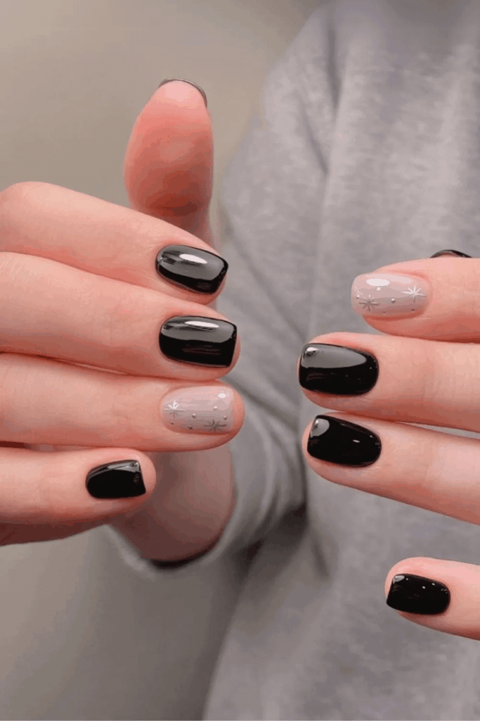 Solid Black Nails with Gold Chrome Star Accents December by nailalamode