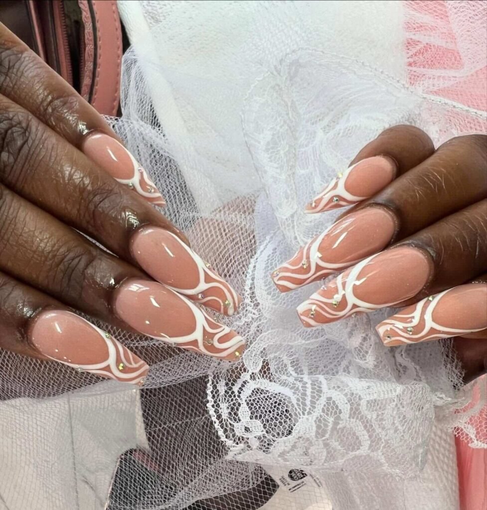 White French tip nails with lace swirl accents by nailsbyvanessab