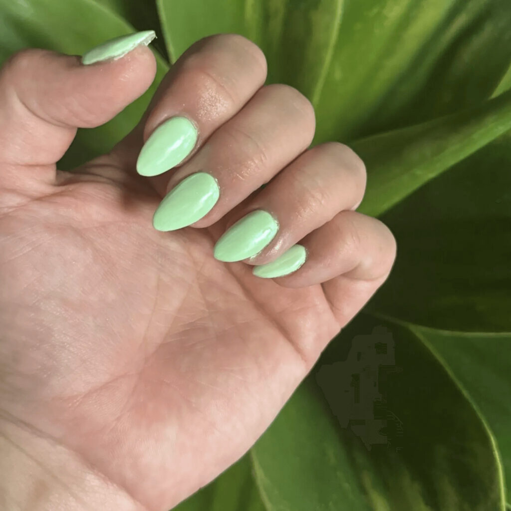 Almond-shaped acrylic nails in a mint green. by brushednailsalon