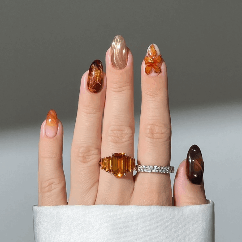 Amber mismatched nails with chunky 3D floral gel accents. by heygreatnails