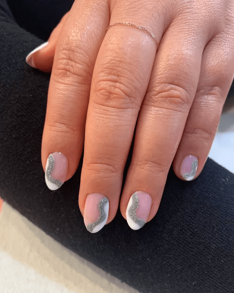 Classic French mani with artful white and silver sparkle swirls. by nailartbymolly
