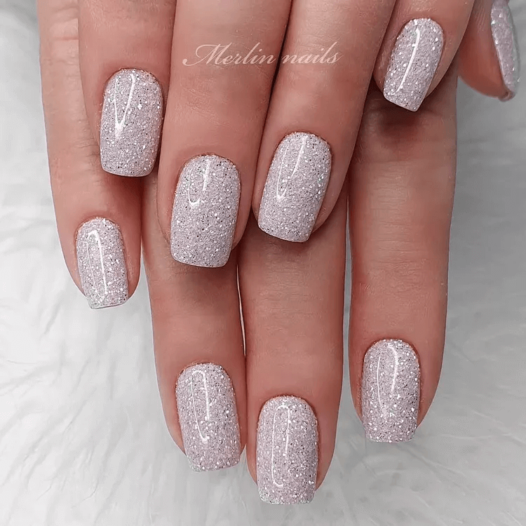 Creamy white nails adorned with tiny silver flatback rhinestones. by merlin_nails