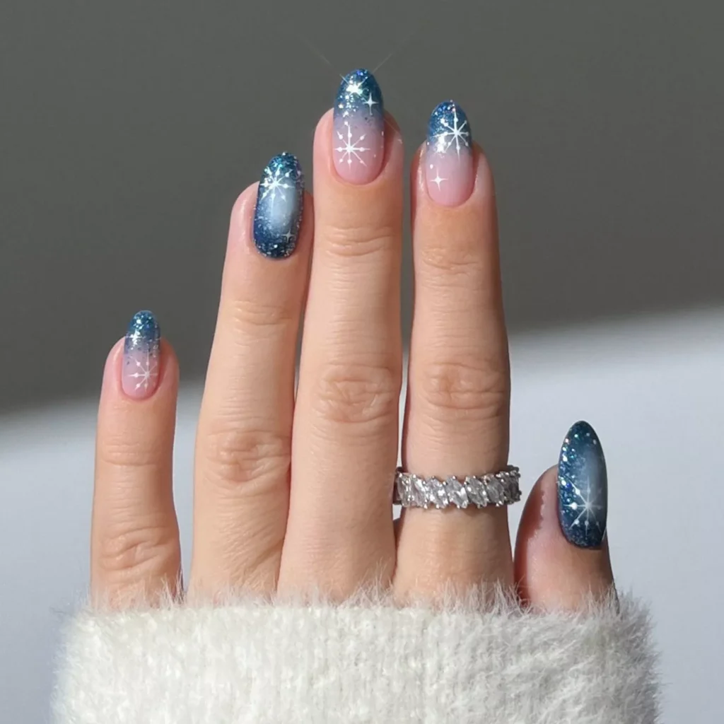 Glitter Blue Aura Nails with Snowflake Art by heygreatnails
