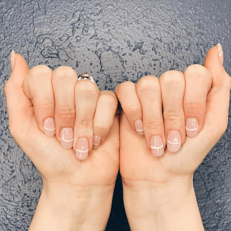 Minimalist single white lines on nude short acrylics. by nailbeautyguide
