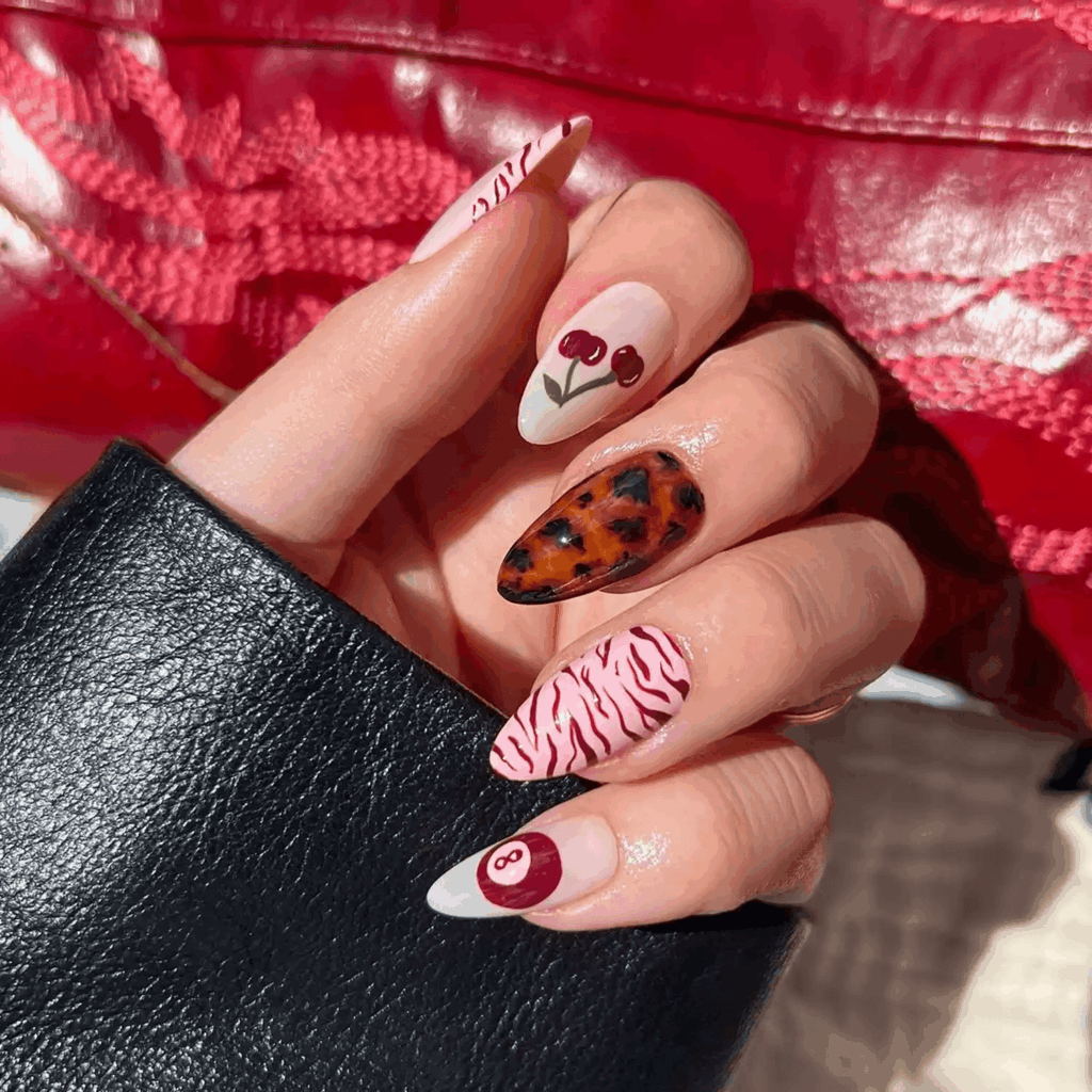 Mismatched nails featuring zebra, cherry, and tortoise print patterns. by pop_polished