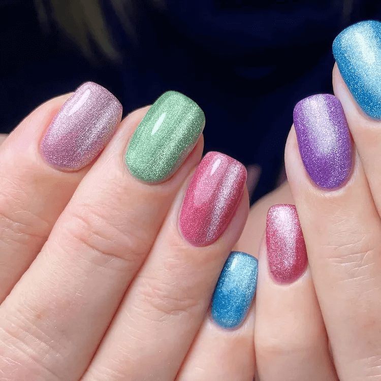 Mismatched skittle nails with bold colors and cat-eye accents. by onenailtorulethemall