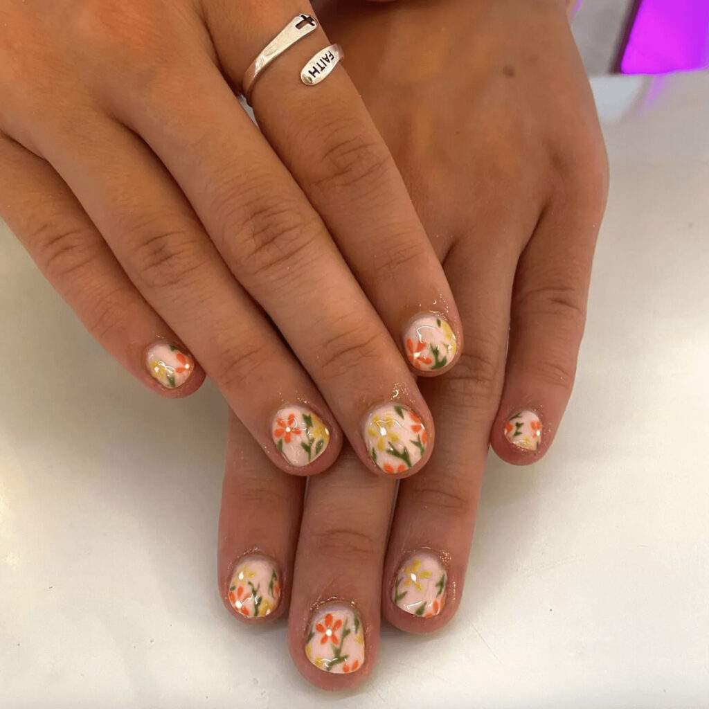 Nude acrylics with delicate flower designs. by rsbnails
