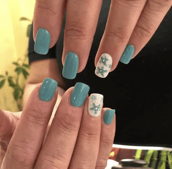 Ocean-themed blue nails with a small starfish charm. by nailbeautyguide