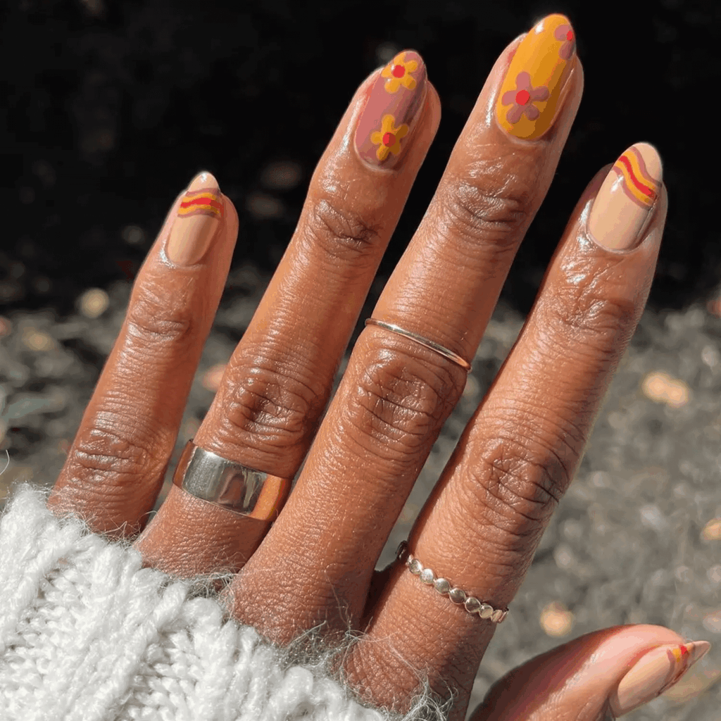Orange, cream, and brown nails with daisy and wavy line designs. by  lolo.nailedit
