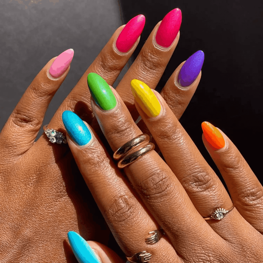 Oval nails with differing shades of rainbow hues. by brushedbyb_