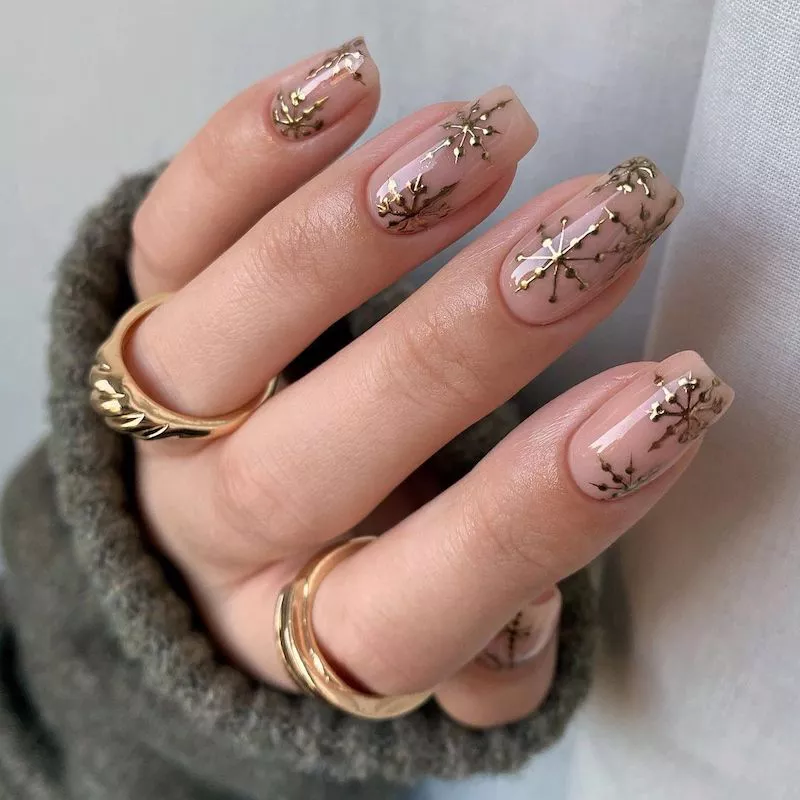 Peachy Nude Nails with Chrome Snowflake Designs by tiffanyabbigailebeauty