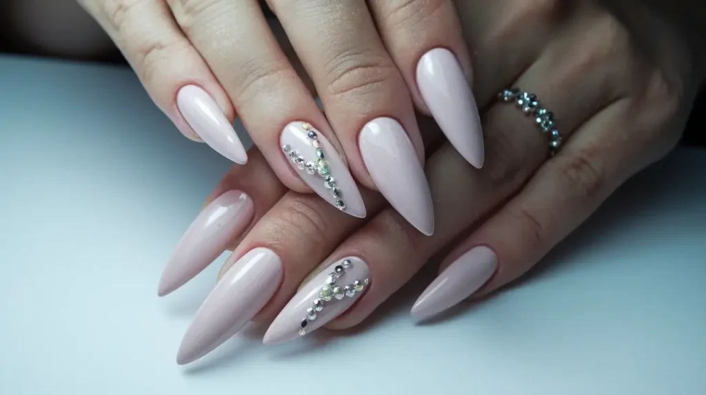 Picture of long, highly tapered Russian almond nail tips, ending in a very refined sharp point. by nailbeautyguide
