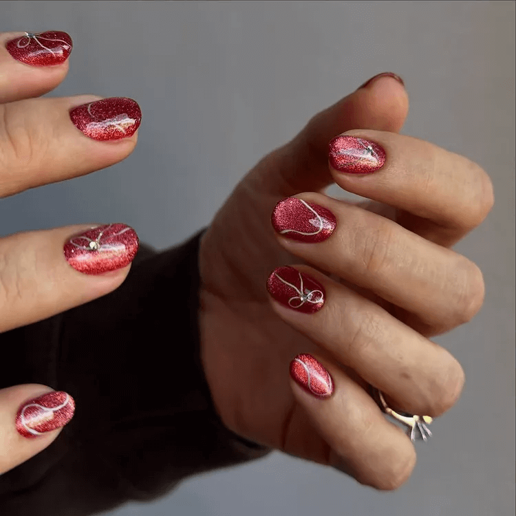 Pink cat-eye nails with delicate 3D bow and ribbon accents. by gossipandgloss
