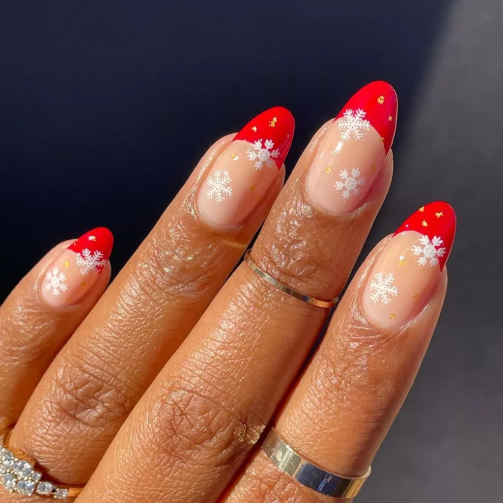 Red French Tips with Detailed Snowflake Art by melanated.mani