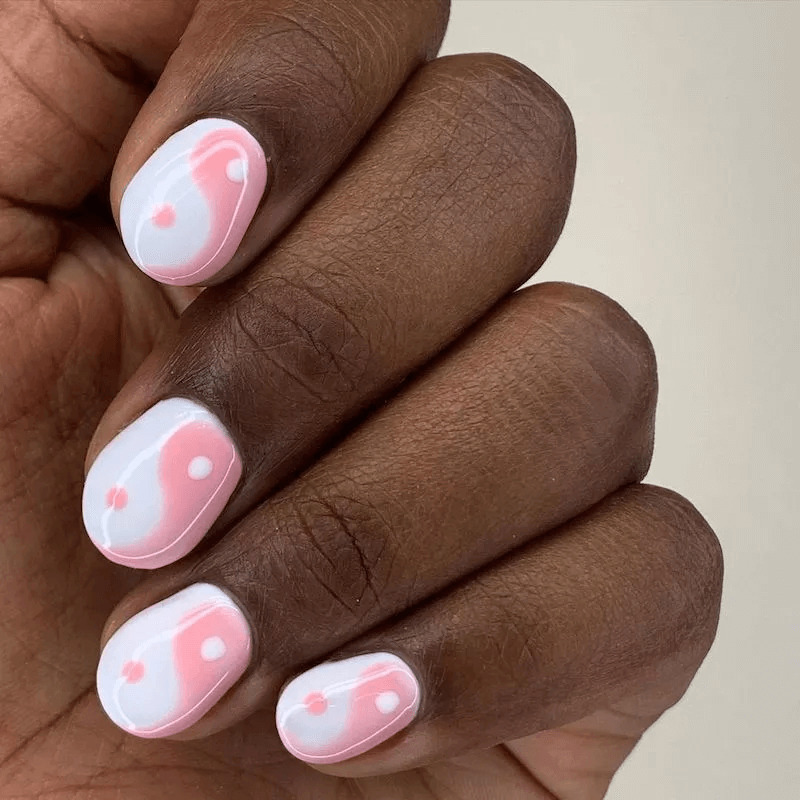 Short acrylics featuring a pink Yin and Yang symbol. by paragonnails
