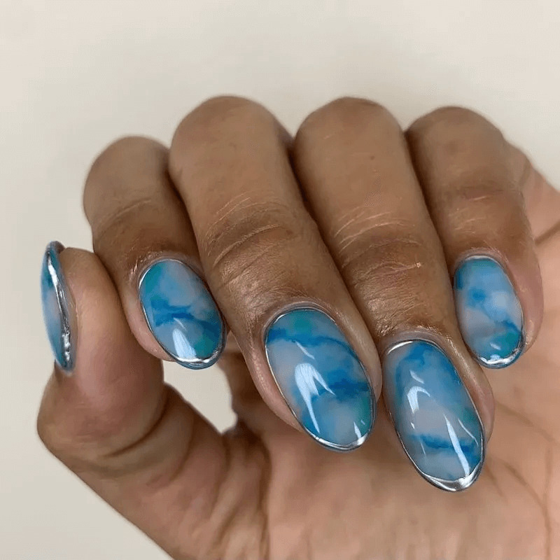 Short acrylics with a beautiful blue Larimar stone design. by paragonnails