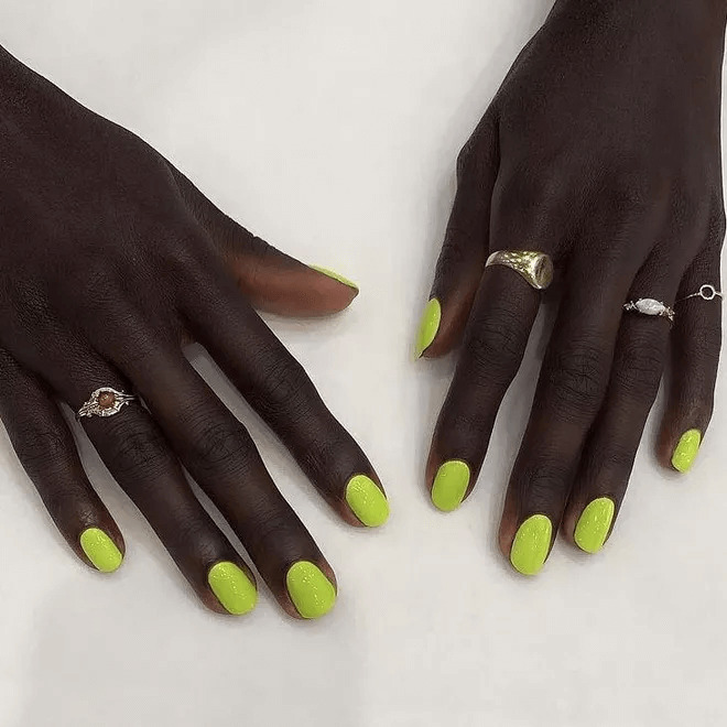 Short acrylics with neon green and glittery nail art. by fancybrownhands