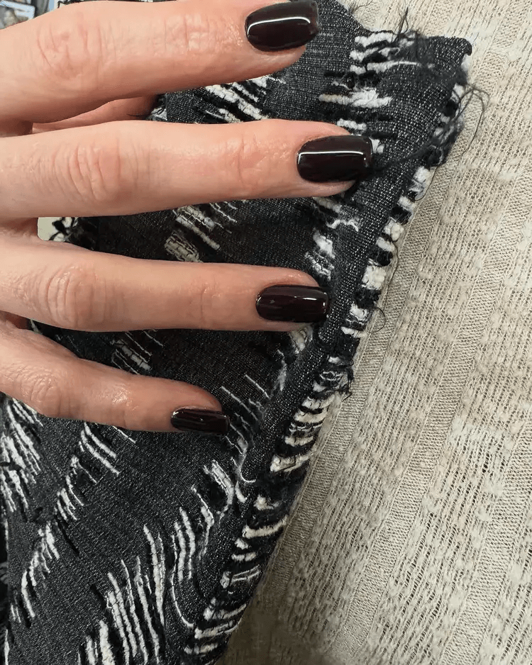 Short, high-gloss nails painted in solid, reflective black. by tipsxtara