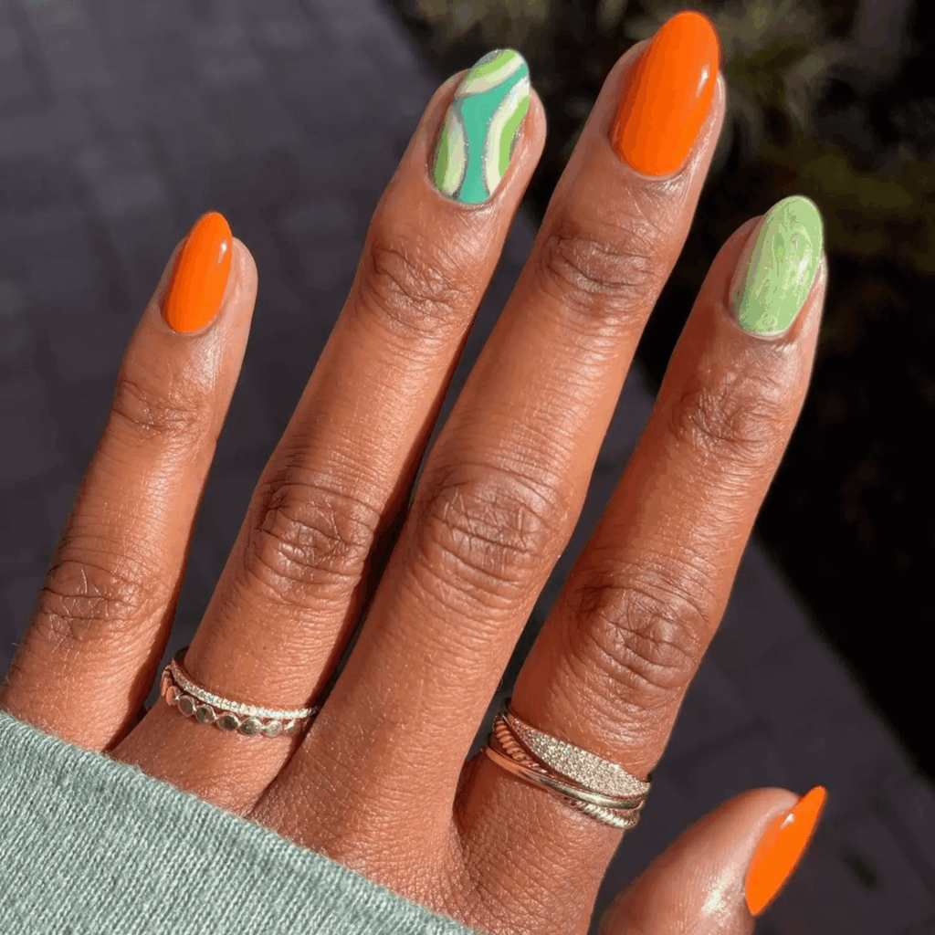 Short orange nails with swirly mint green abstract accent nails. by heluviee