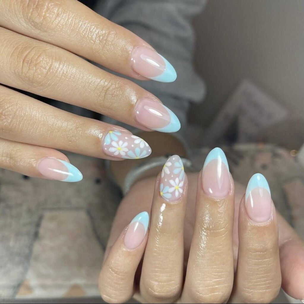 Blue French tips with a touch of spring flowers. by 1999houseofnailsnz
