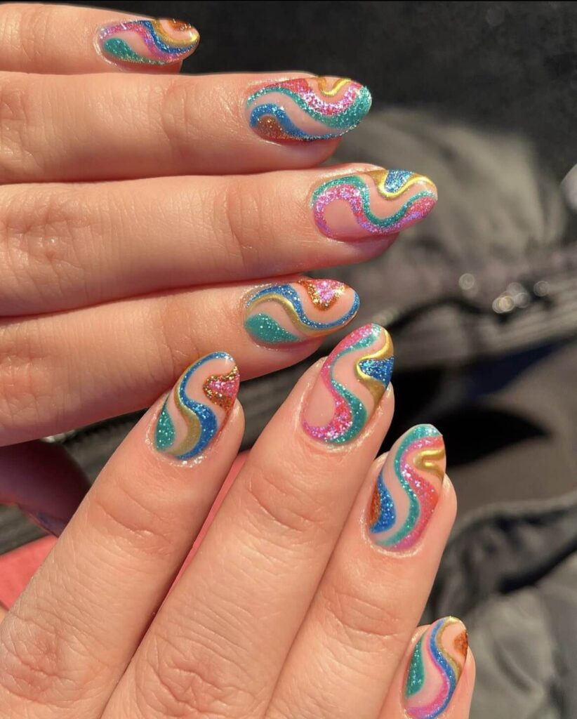Bold and colorful glitter swirl rainbow design. by nailsbyheathere