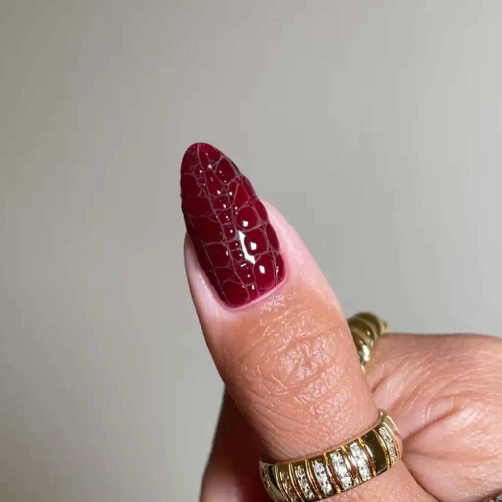 Clear 3D croc application over a garnet base. by nailedbyliv___