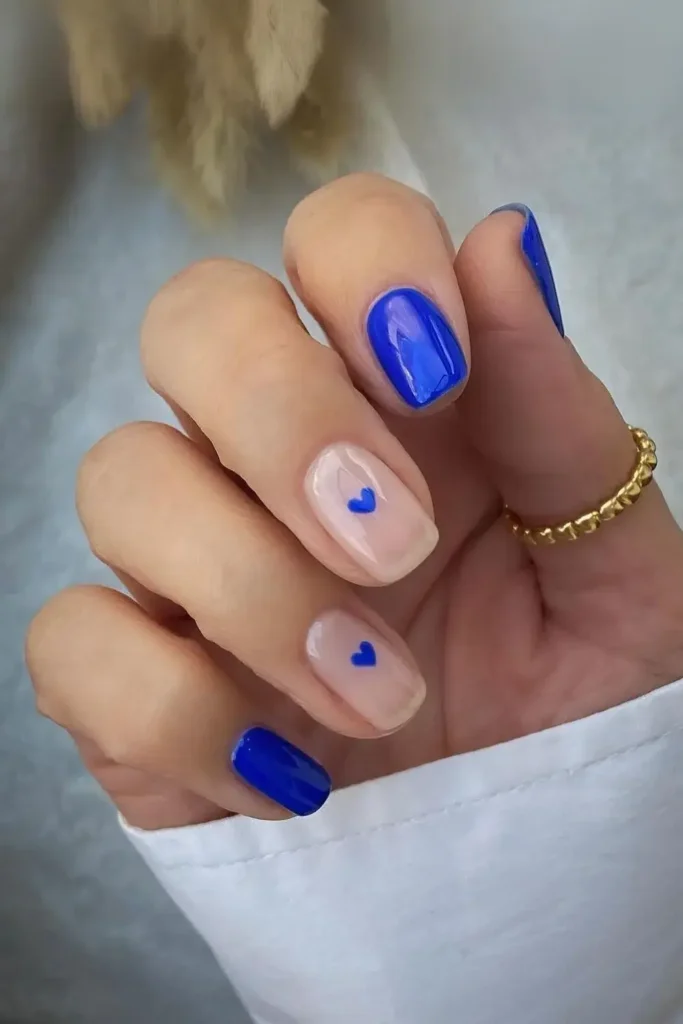 Cobalt blue nails with small heart accents. by lindseysbeautylounge1