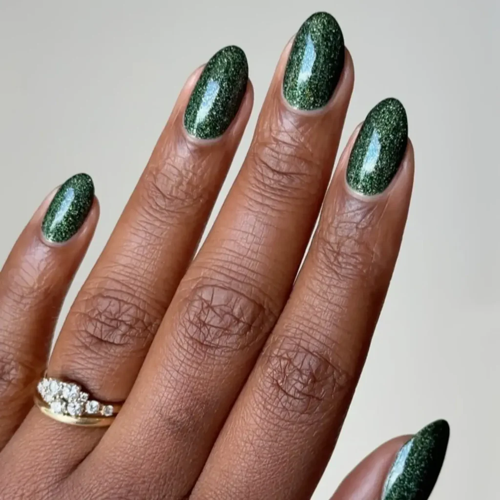 Deep evergreen glitter with a velvet finish. by melanated.mani