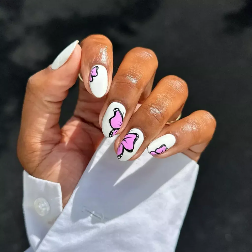 Elegant white nails featuring delicate butterfly designs. by lolo.nailedit