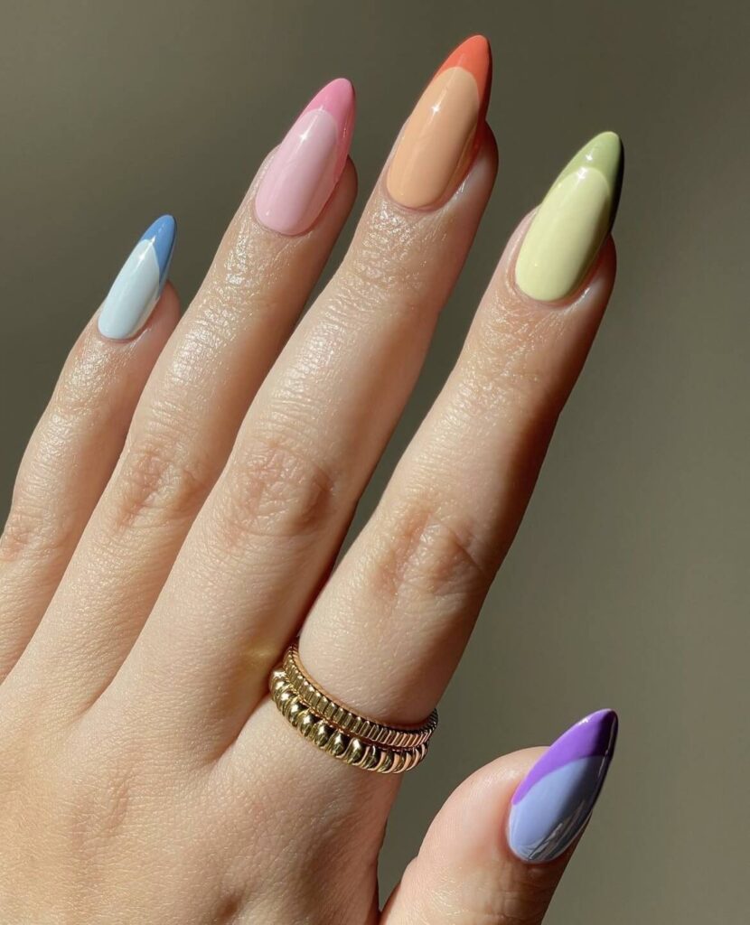 Fun and playful twist on the classic French tips with a rainbow of colors including orange, green, purple, blue, and pink. by avrnailswatches