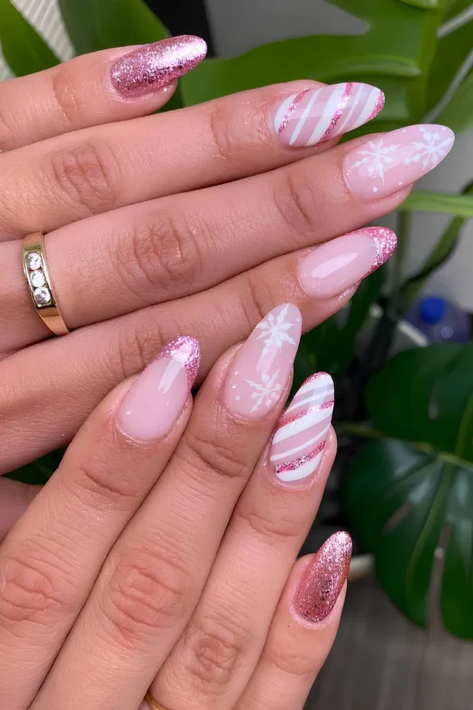 Glittery pink nails with snowflakes and candy swirl art. by nylove_nail