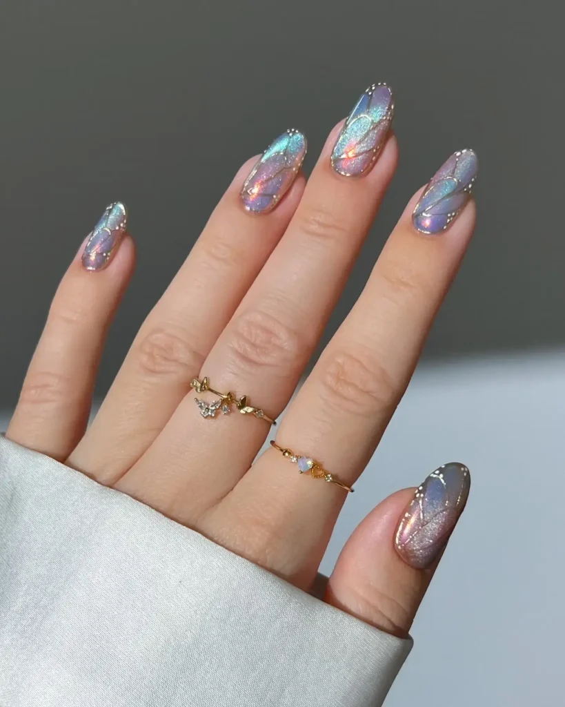 Image of iridescent, slightly translucent nails that shimmer with pink and blue light, resembling fairy wings. by heygreatnails