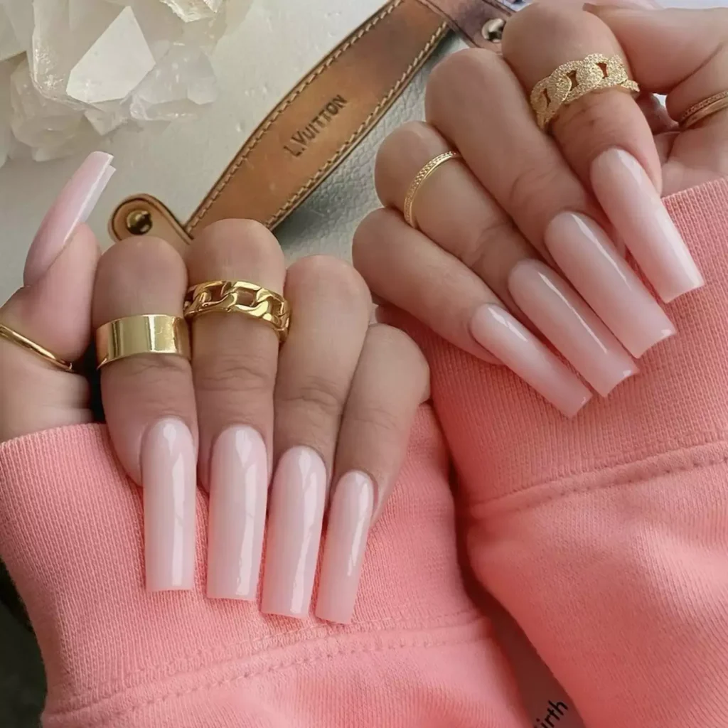 Image of long, square-tipped acrylic nails painted a soft pale pink nude. by chaunlegend