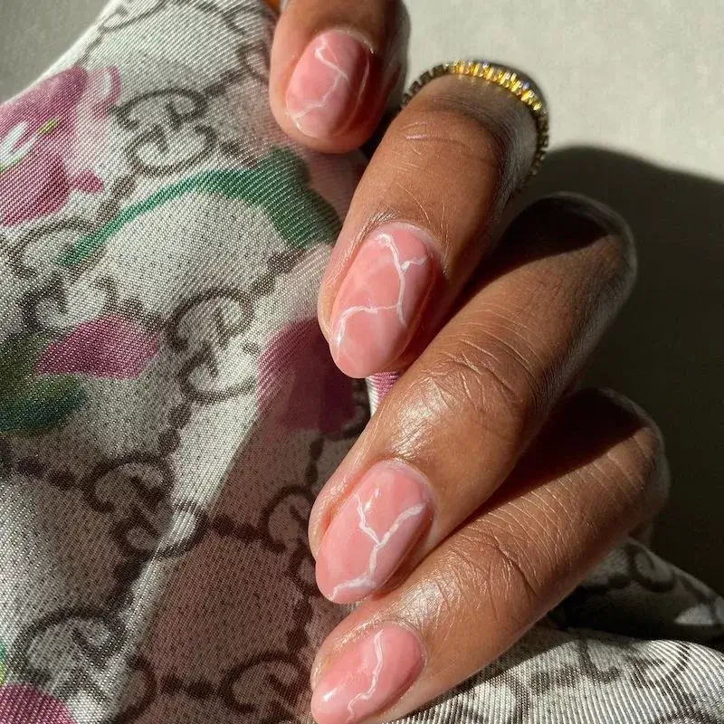 Image of medium-length nails featuring a delicate pale pink and white marble pattern. by lolo.nailedit

