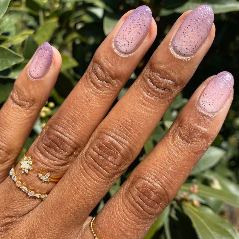Image of nails featuring a deep mauve shimmer polish fading into a lighter clear shade toward the cuticle. by lolo.nailedit