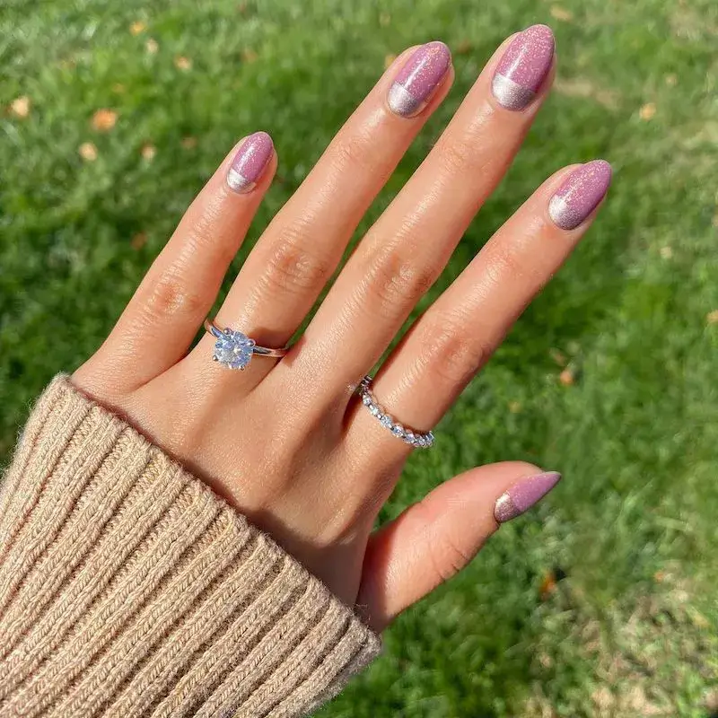Image of nails painted in a sparkly mauve hue with a thin, solid metallic silver stripe traced near the cuticle. by amyytran