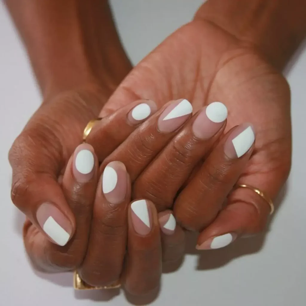 Matte white nails featuring bold abstract designs. by imarninails