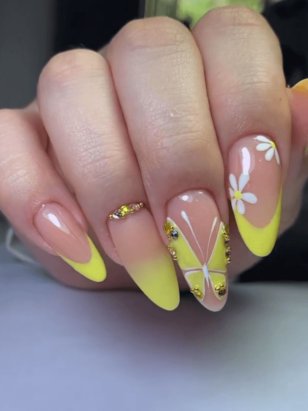 Mix of French tips, ombre, and light butterfly nail art in cheerful yellow shades. by moleroaleimar.nails