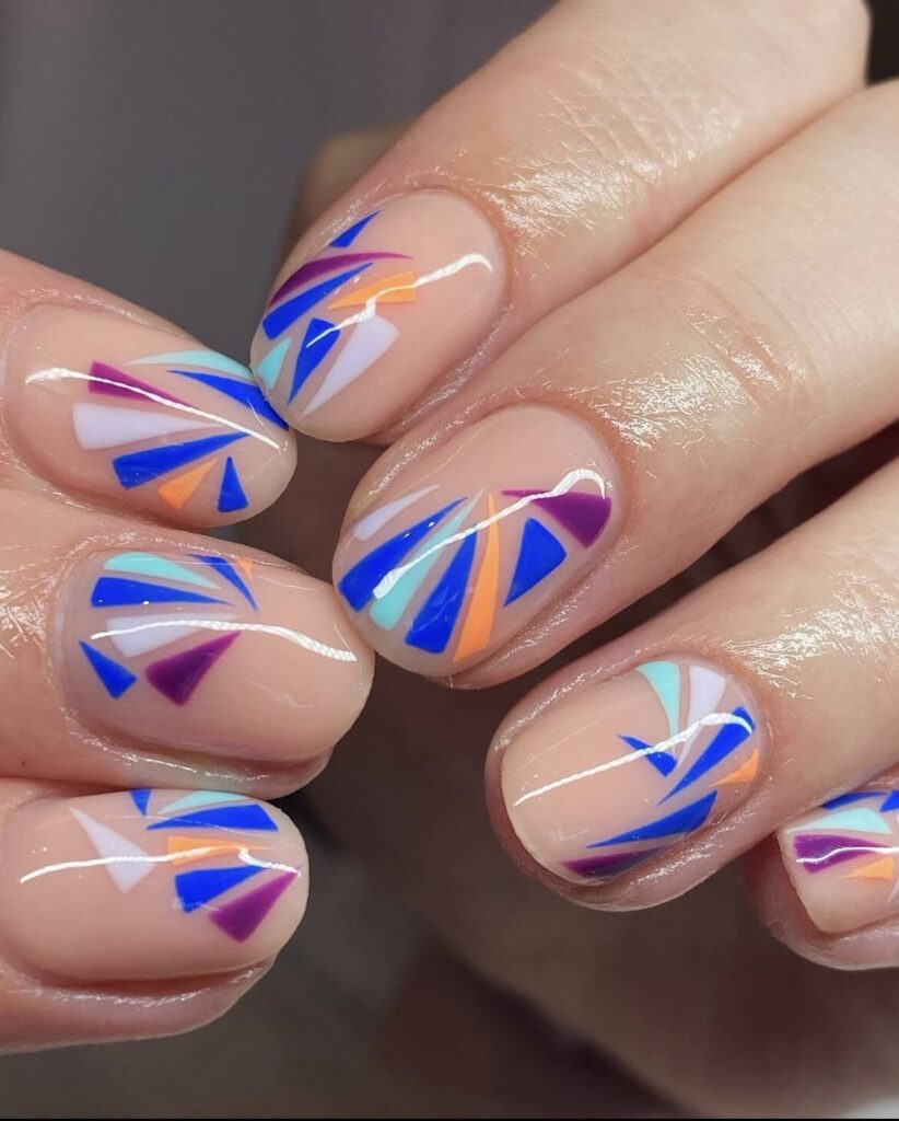 Neutral nude color, accented by abstract designs in shades of blue, white, and purple. by yanpaintsnails