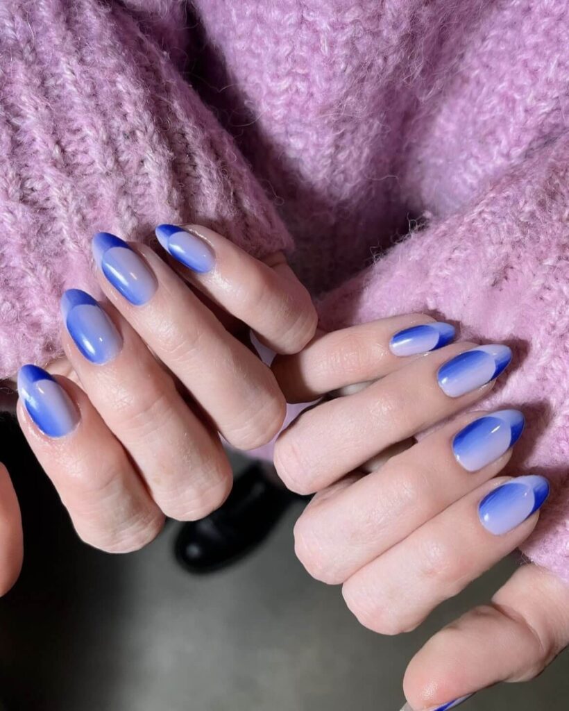 Ombre design in shades of blue, paired with classic French tips. by nailsbyheathere
