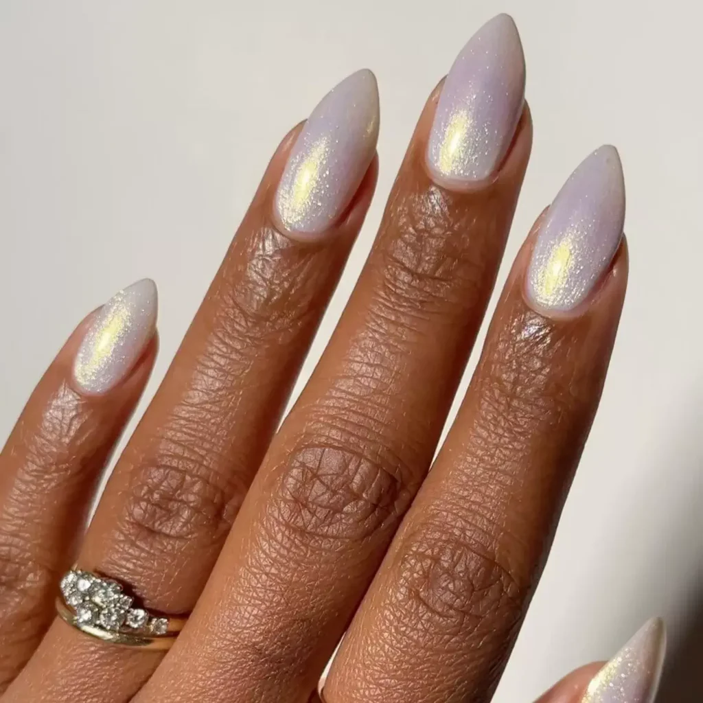 Pearly white almond-shaped nails with subtle shine. by melanated.mani

