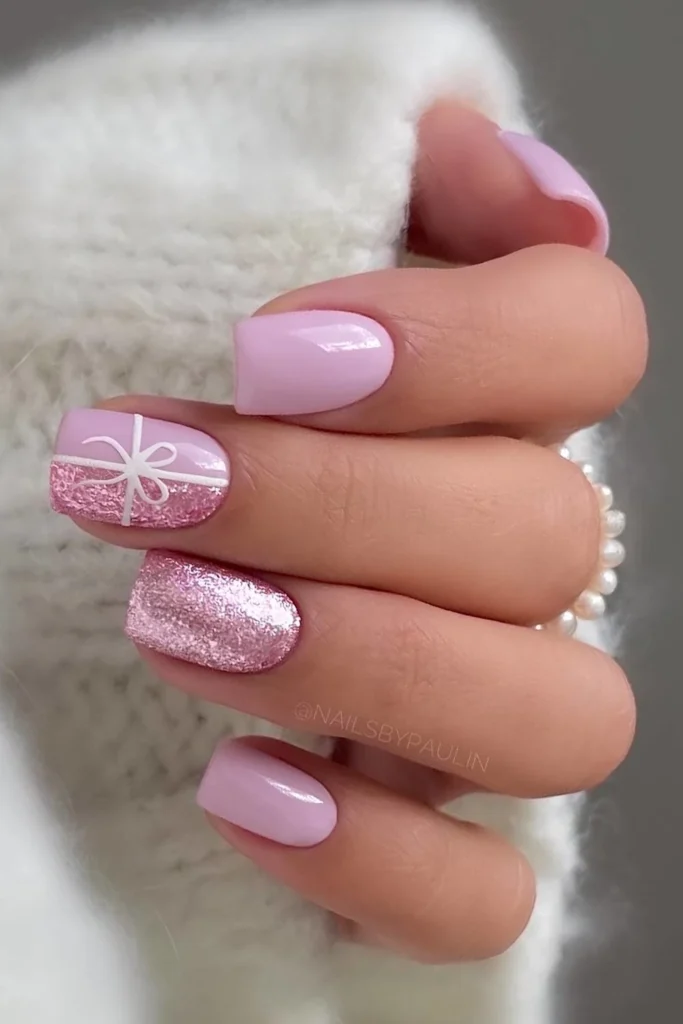 Pink Christmas nails with bows and glitter. by nailsbypaulin