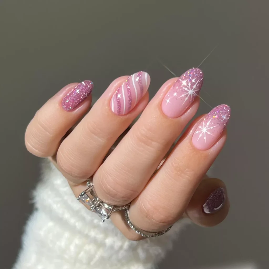 Pink glitter ombré Christmas nails with star accents and candy cane stripes by heygreatnails
