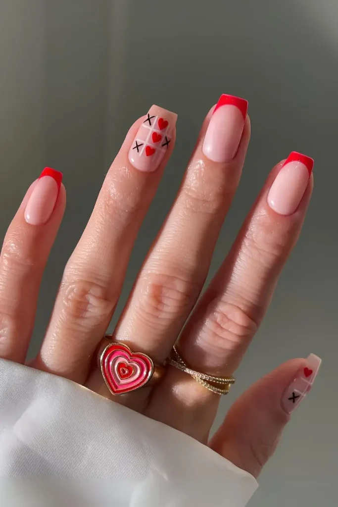Red French tips with heart and cross art in a tic-tac-toe pattern. by gelsbybry
