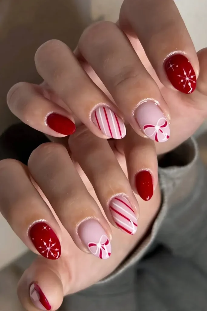 Red and white nails with stripes and bow art. by silkbeauty.uk
