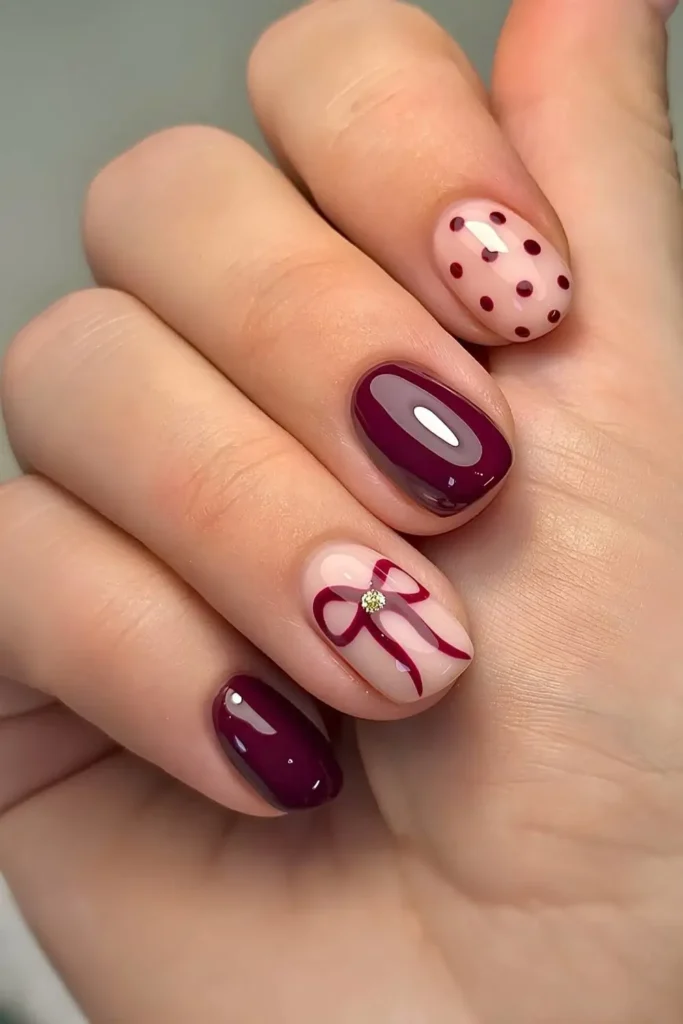 Short burgundy nails with bows and polka dots. by biab.byjem_
