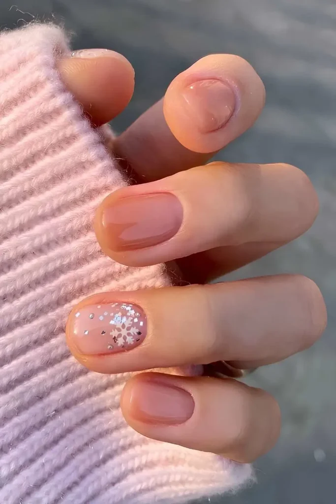 Short nude nails with snowflakes and gold foil. by nailalamode
