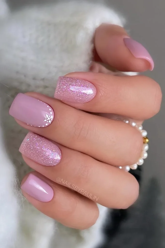 Short pink glitter mani with snowflakes. by nailsbypaulin