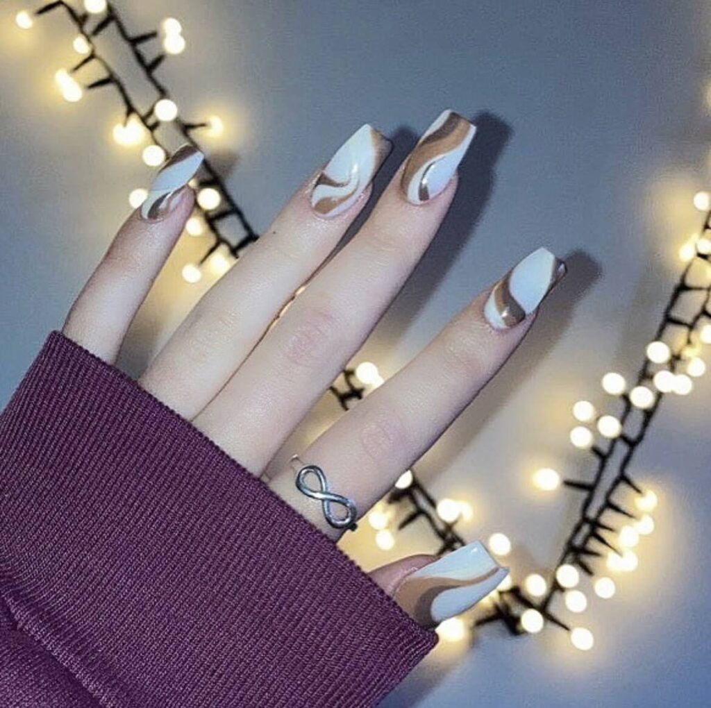 Simple white base with swirling coffee brown art. by 1999houseofnailsnz