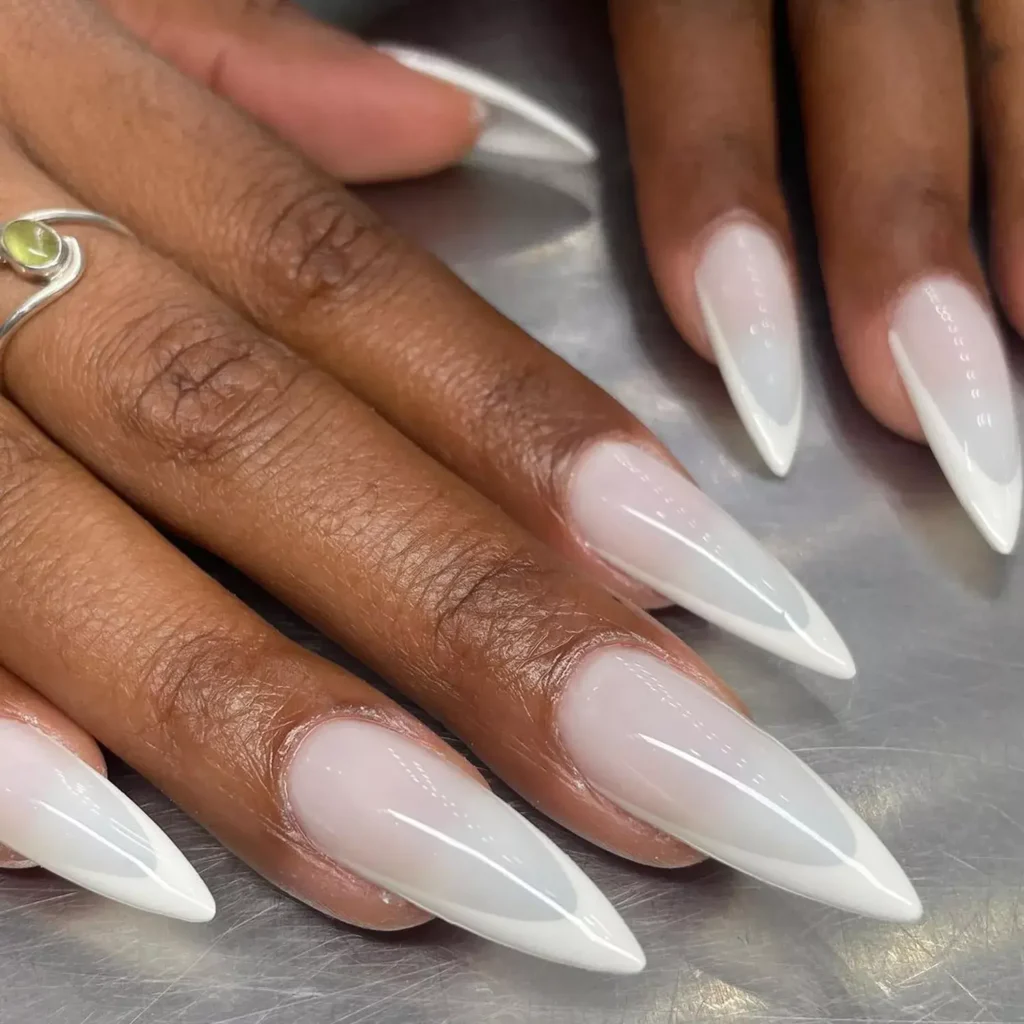 Soft milky tips on sharp stiletto nails for sophistication. by digitzbydev

